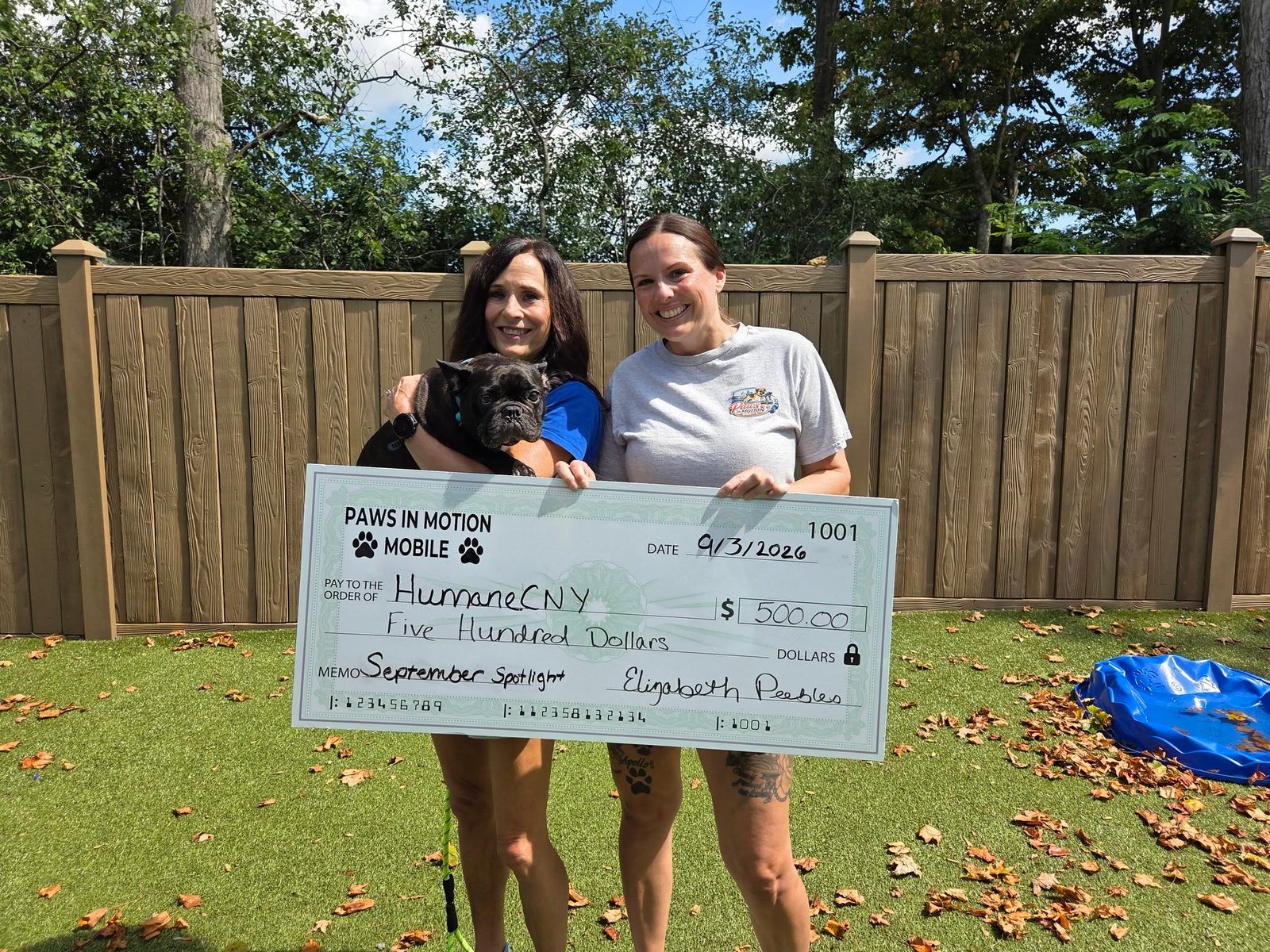 Liz presenting a $500 check to HumaneCNY